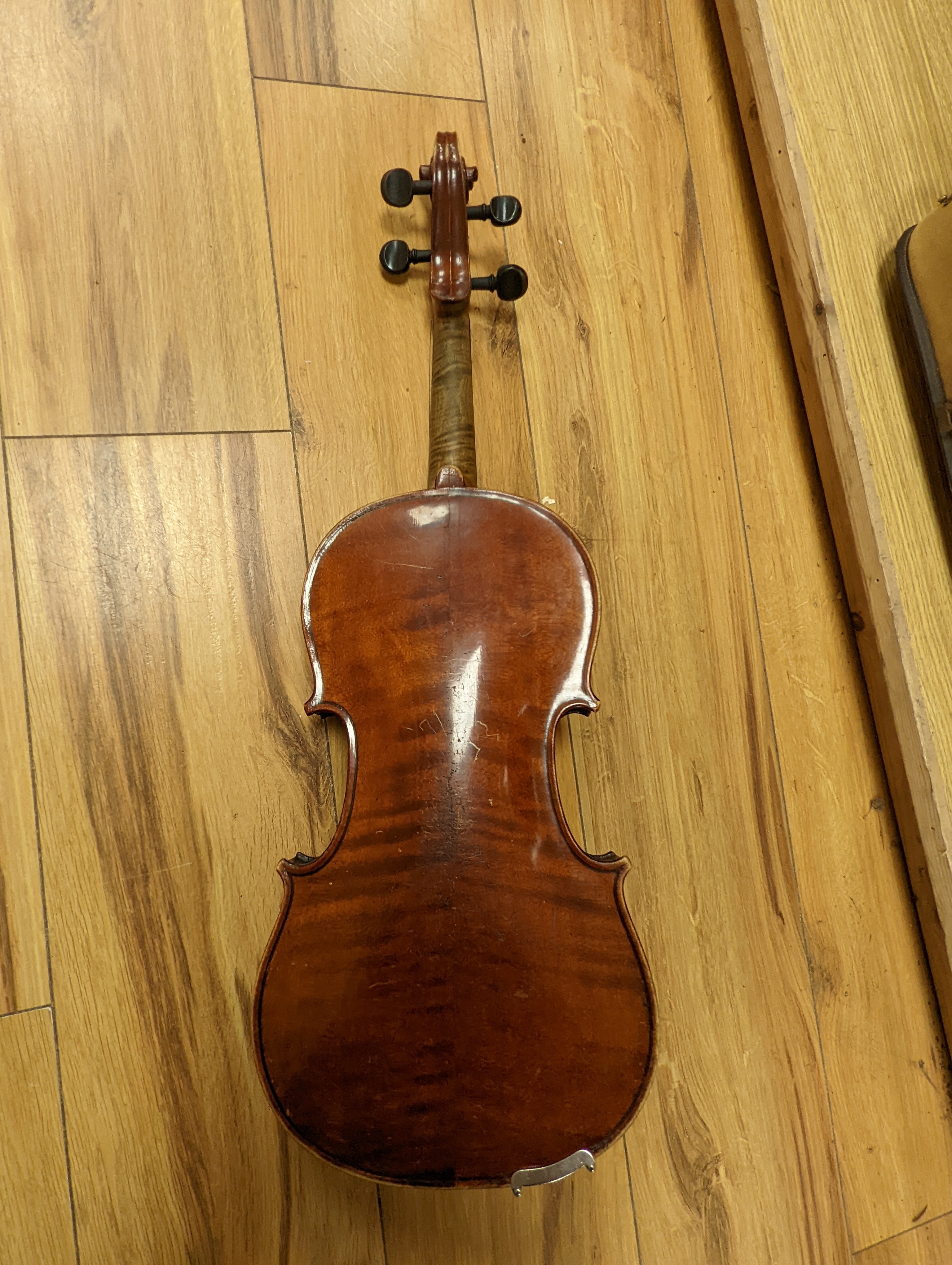 An early 20th century French vioilin, cased with bow and a cased saxon violin